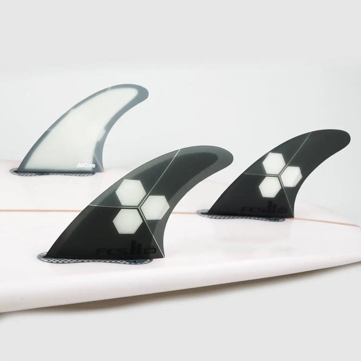 FCS II THRUSTER Al Merrick PC+AirCore (Med-Large) Grey on a surfboard