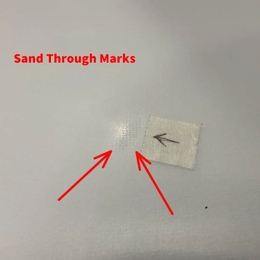 Close up picture of a minor ding visible on the surfboard